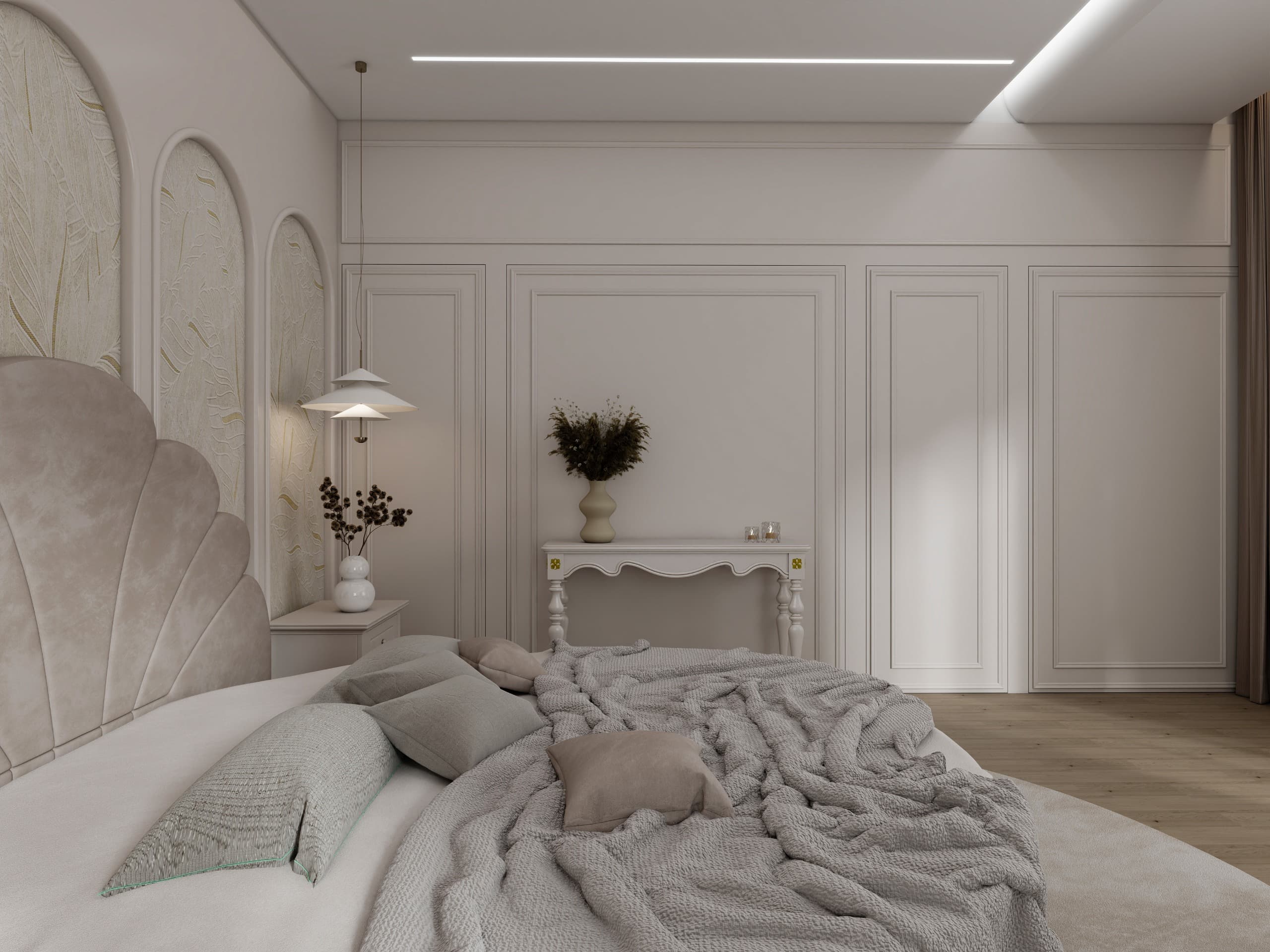 The round bed seen from its foot, towards a panelled wardrobe wall and a scallop-edged console under a cove-lit ceiling