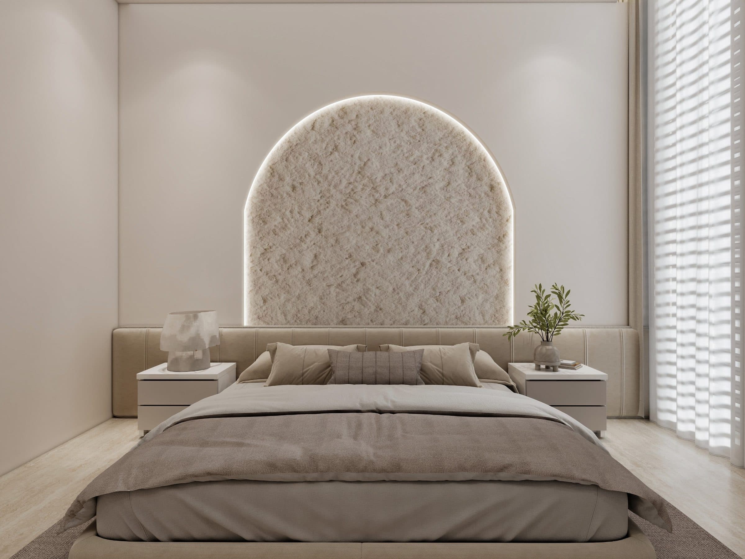 Master bedroom with a backlit arched niche of rough plaster above a channel-tufted headboard