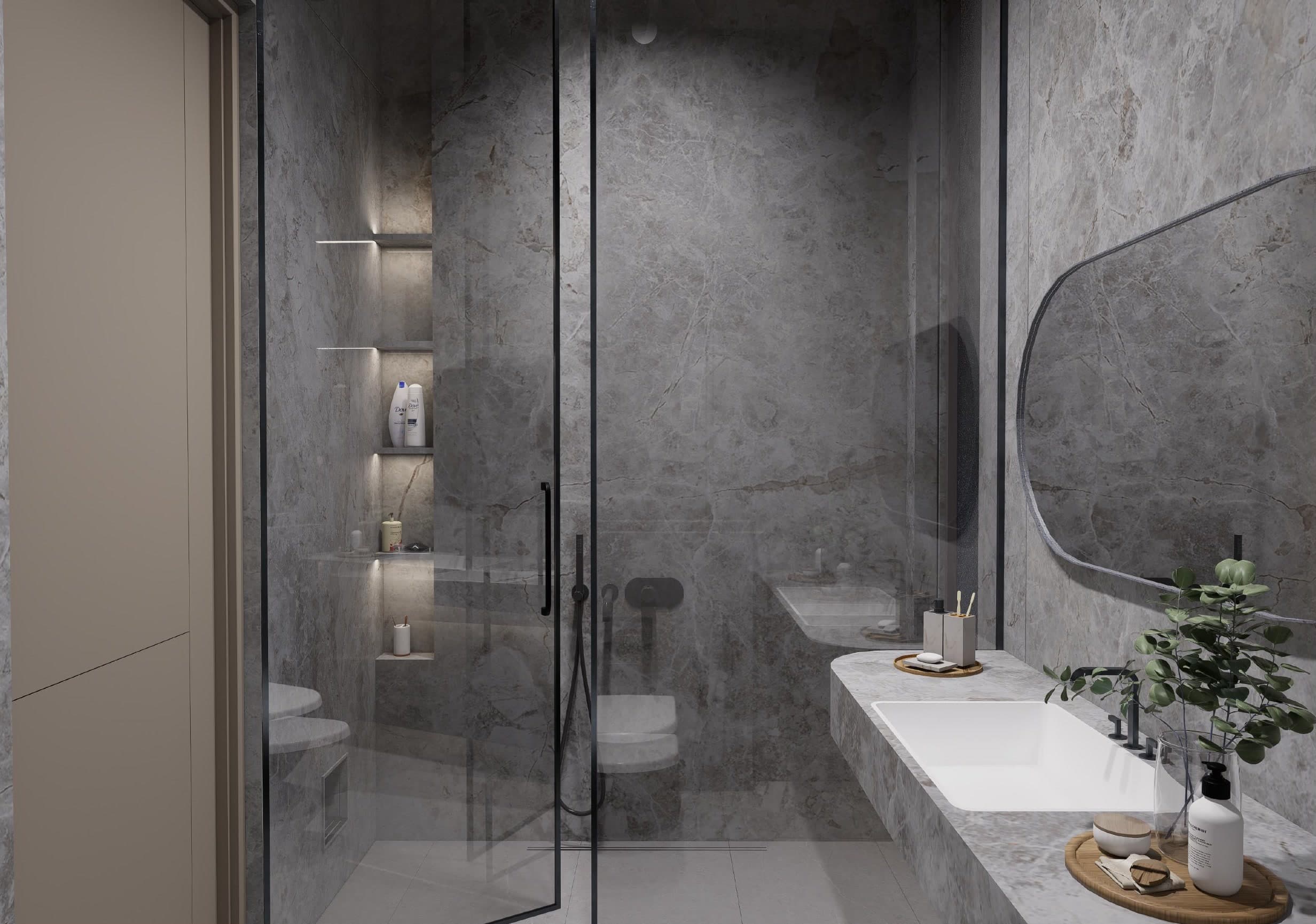 Shower enclosure in grey marble with backlit niche shelving, seen past the vanity