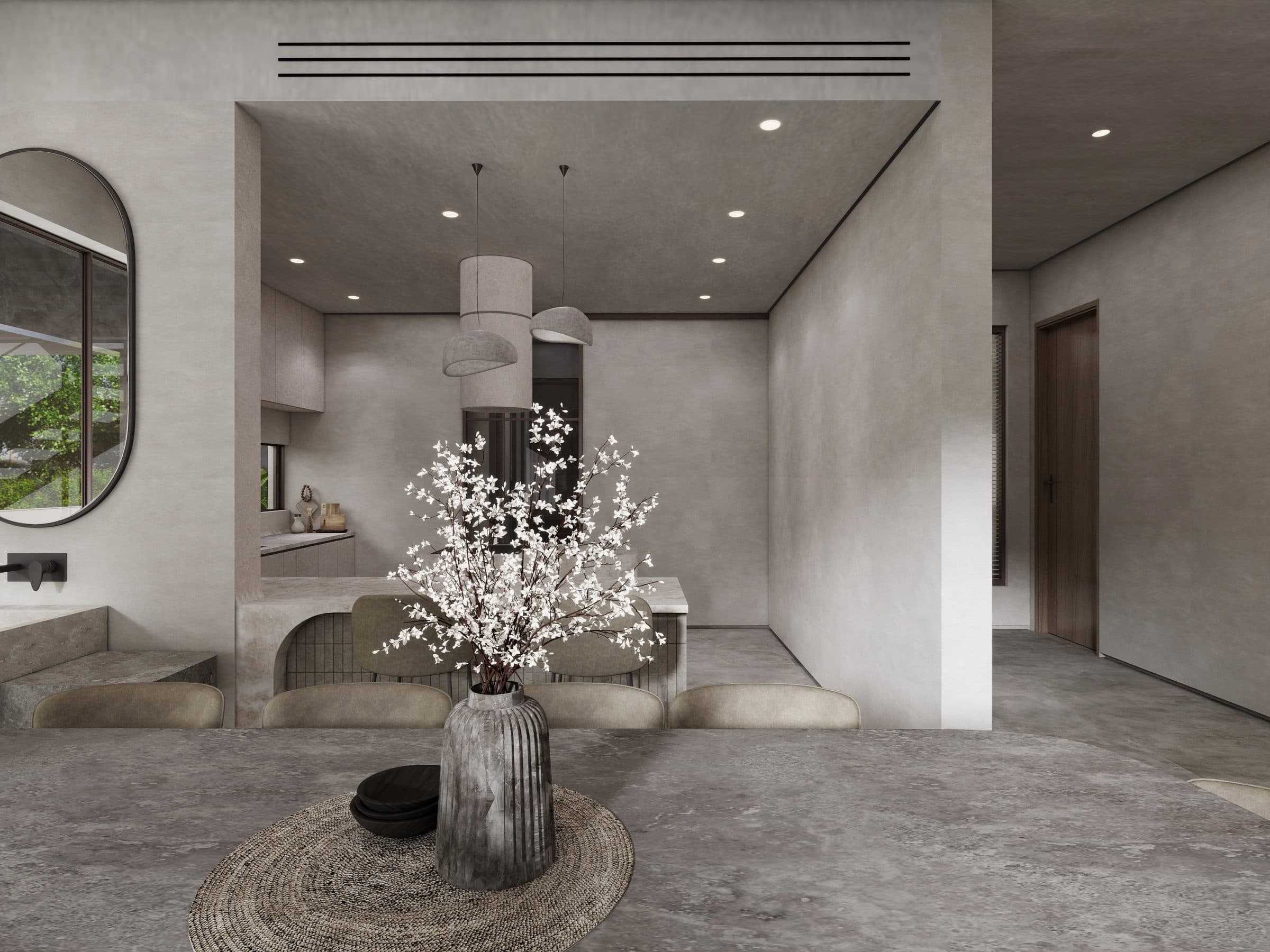 Dining table in the foreground, looking through to the kitchen and a stone washbasin