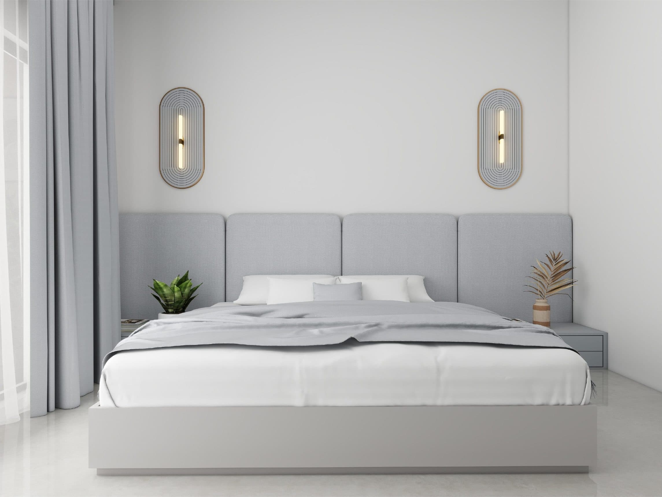 Bedroom with a panelled upholstered headboard between paired oval brass wall lights